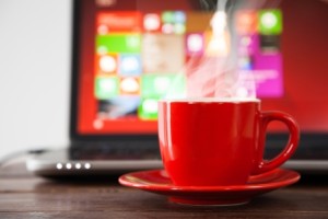 Laptop and a cup of coffee on a table